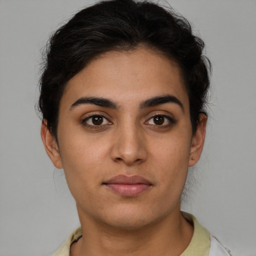 Joyful latino young-adult female with short  brown hair and brown eyes