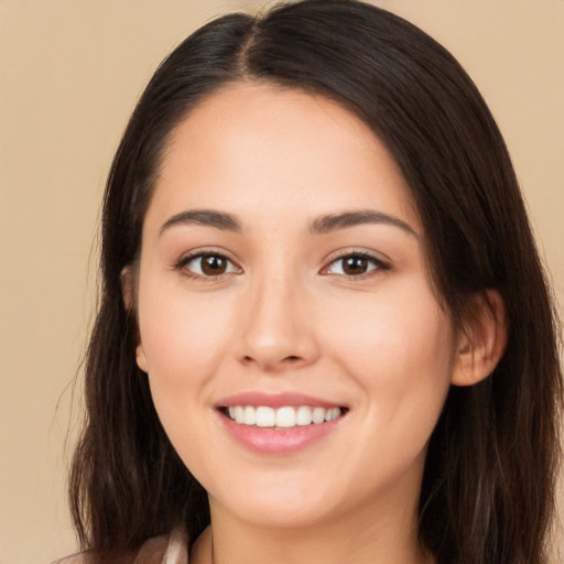 Joyful white young-adult female with long  brown hair and brown eyes