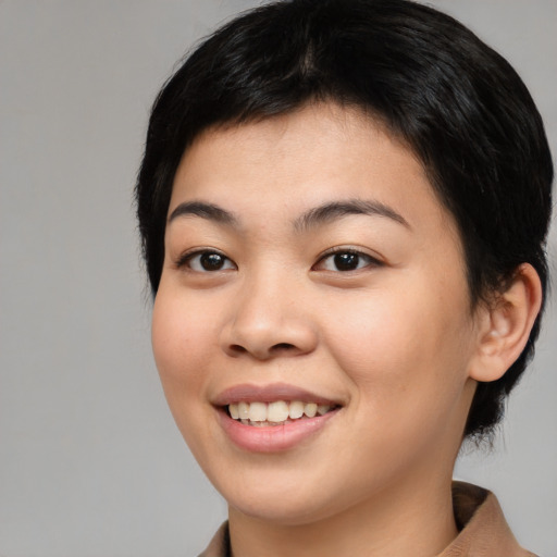 Joyful asian young-adult female with medium  black hair and brown eyes