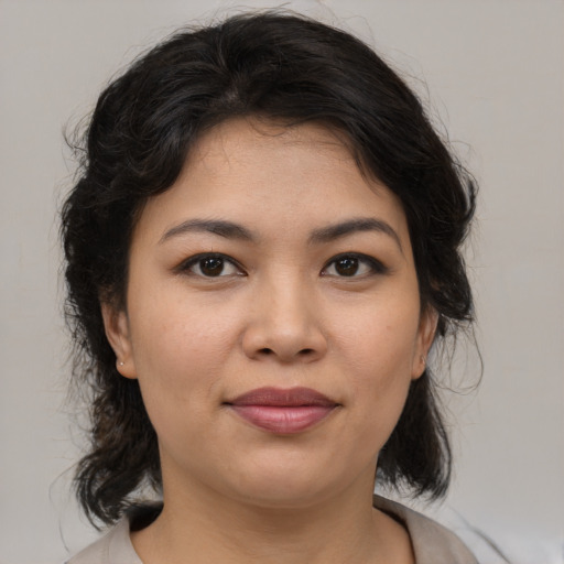 Joyful latino young-adult female with medium  brown hair and brown eyes