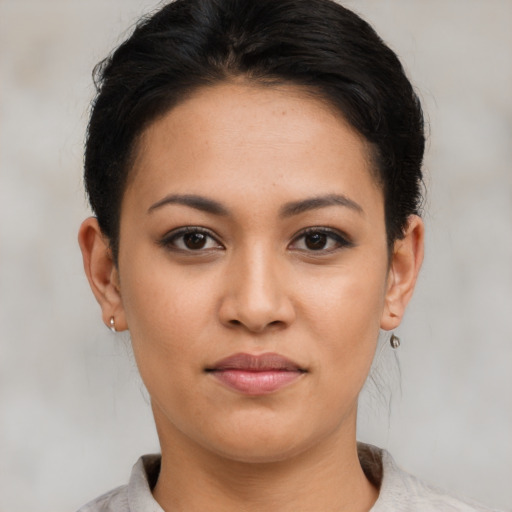 Joyful latino young-adult female with short  brown hair and brown eyes