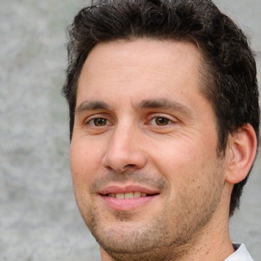 Joyful white adult male with short  brown hair and brown eyes