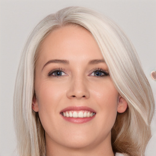 Joyful white young-adult female with long  brown hair and blue eyes