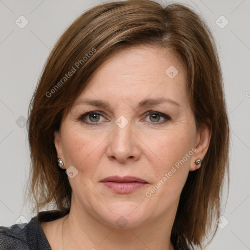 Joyful white adult female with medium  brown hair and grey eyes