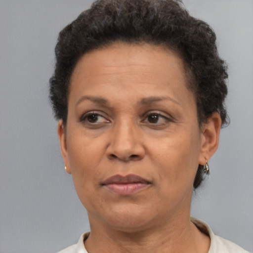 Joyful black adult female with short  brown hair and brown eyes
