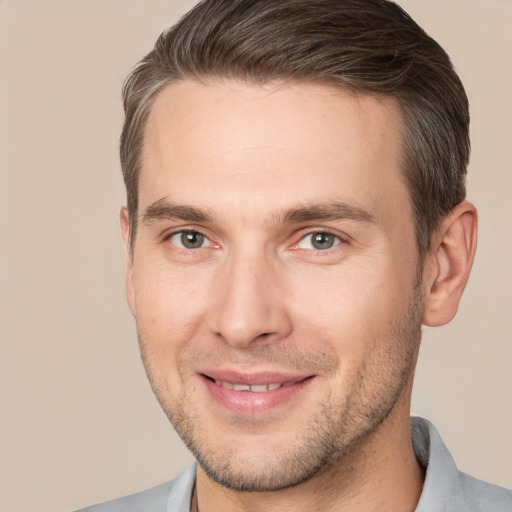 Joyful white young-adult male with short  brown hair and brown eyes