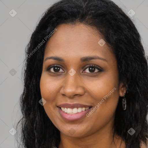 Joyful black young-adult female with long  brown hair and brown eyes