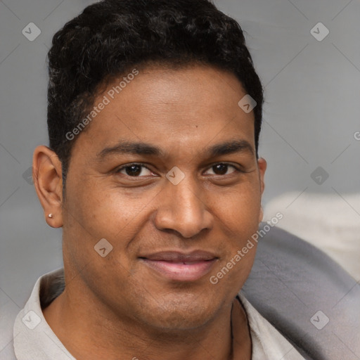 Joyful latino young-adult male with short  brown hair and brown eyes