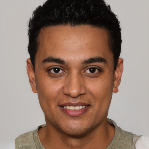 Joyful latino young-adult male with short  black hair and brown eyes