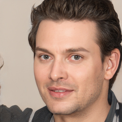 Joyful white adult male with short  brown hair and brown eyes