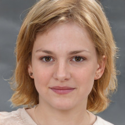 Joyful white young-adult female with medium  brown hair and blue eyes