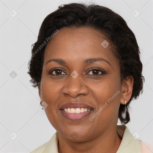 Joyful black adult female with short  brown hair and brown eyes