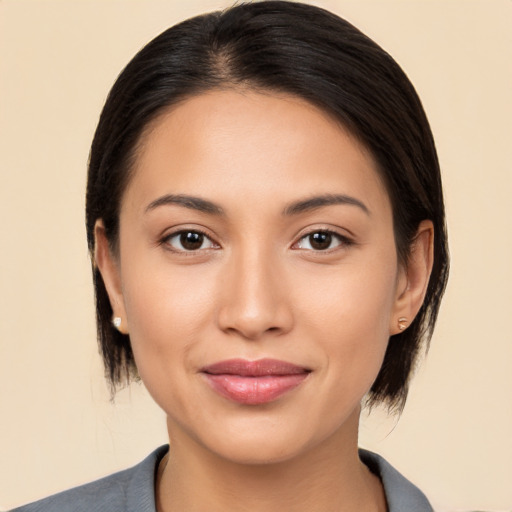 Joyful latino young-adult female with medium  brown hair and brown eyes