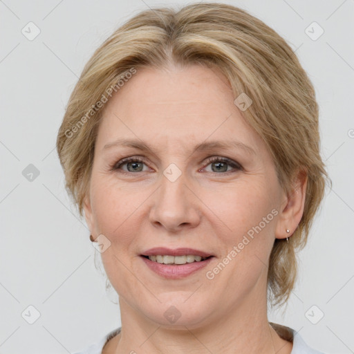 Joyful white adult female with medium  brown hair and grey eyes