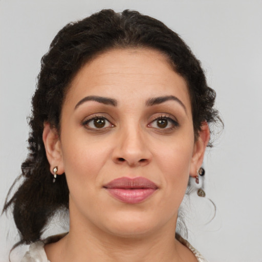 Joyful latino young-adult female with medium  brown hair and brown eyes