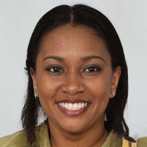 Joyful black young-adult female with long  brown hair and brown eyes