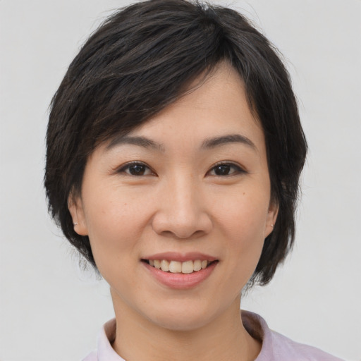 Joyful asian young-adult female with medium  black hair and brown eyes