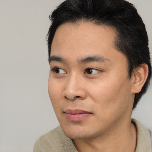 Joyful white young-adult male with short  black hair and brown eyes