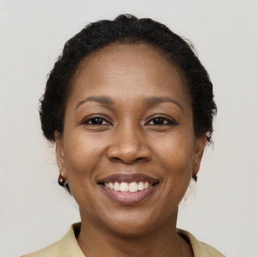 Joyful black adult female with short  brown hair and brown eyes