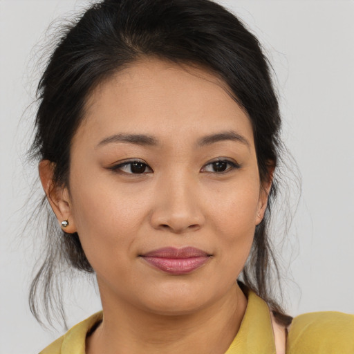 Joyful asian young-adult female with medium  brown hair and brown eyes