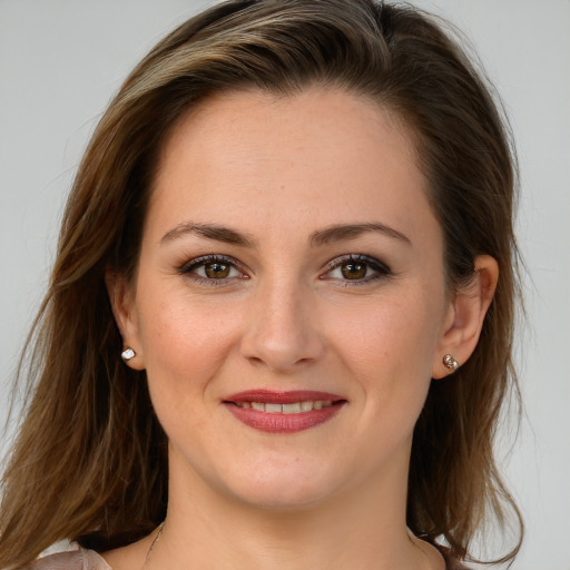 Joyful white young-adult female with long  brown hair and brown eyes