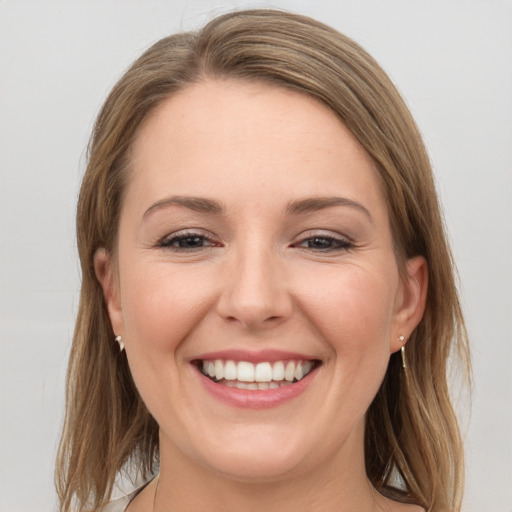 Joyful white young-adult female with medium  brown hair and grey eyes