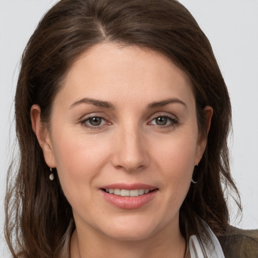 Joyful white young-adult female with medium  brown hair and grey eyes