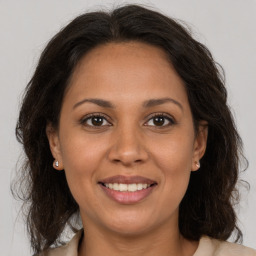 Joyful white adult female with medium  brown hair and brown eyes