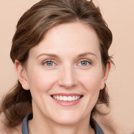 Joyful white young-adult female with medium  brown hair and blue eyes