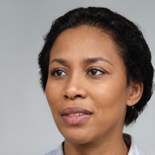 Joyful black young-adult female with medium  black hair and brown eyes