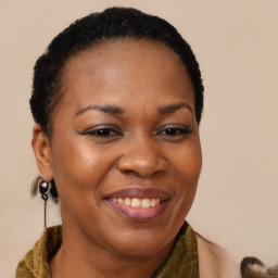 Joyful black adult female with long  brown hair and brown eyes