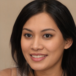 Joyful asian young-adult female with long  brown hair and brown eyes