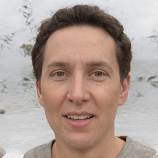 Joyful white adult male with short  brown hair and grey eyes