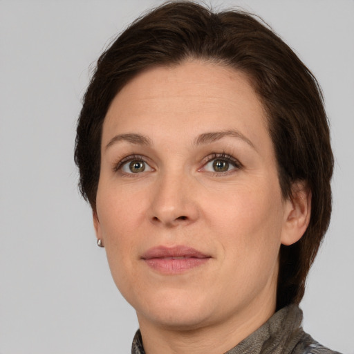 Joyful white adult female with medium  brown hair and brown eyes