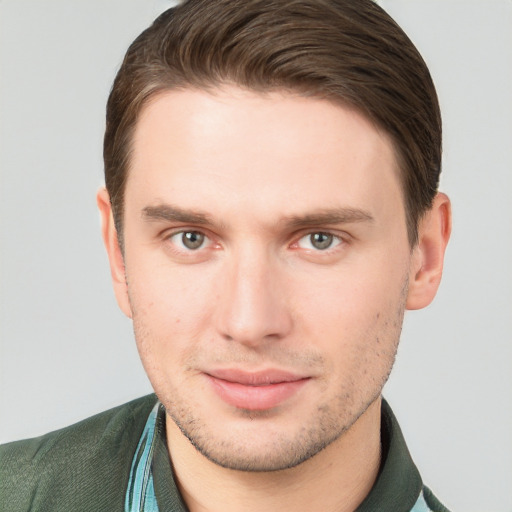 Joyful white young-adult male with short  brown hair and grey eyes