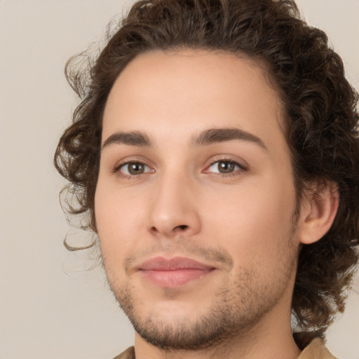 Joyful white young-adult male with medium  brown hair and brown eyes