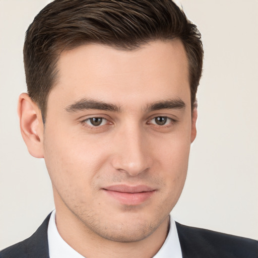 Joyful white young-adult male with short  brown hair and brown eyes