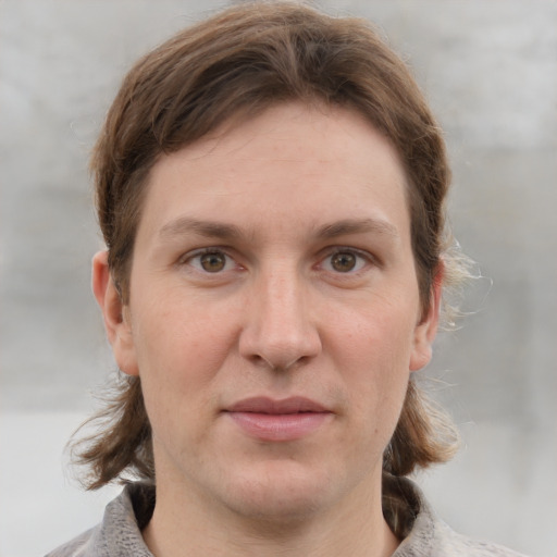 Joyful white adult female with medium  brown hair and grey eyes