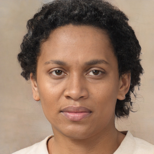 Joyful black adult female with short  brown hair and brown eyes
