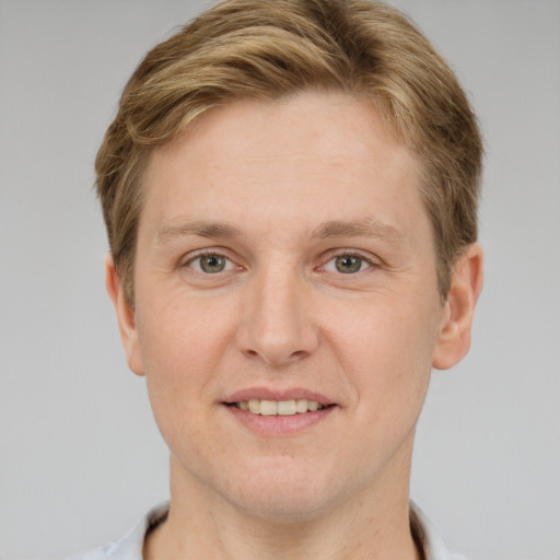 Joyful white adult male with short  brown hair and grey eyes