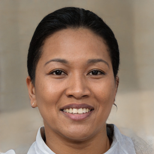 Joyful asian young-adult female with short  black hair and brown eyes
