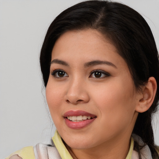 Joyful asian young-adult female with medium  brown hair and brown eyes