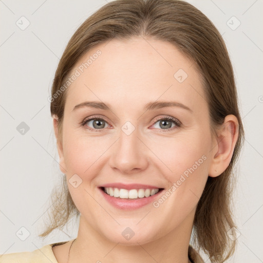 Joyful white young-adult female with medium  brown hair and grey eyes