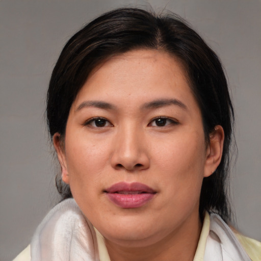 Joyful asian young-adult female with medium  brown hair and brown eyes