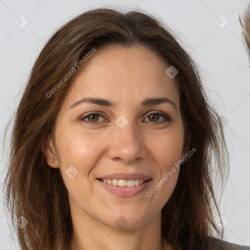 Joyful white adult female with long  brown hair and brown eyes