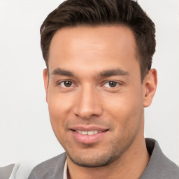 Joyful white young-adult male with short  brown hair and brown eyes