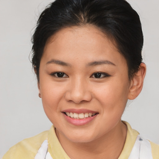 Joyful asian young-adult female with short  brown hair and brown eyes