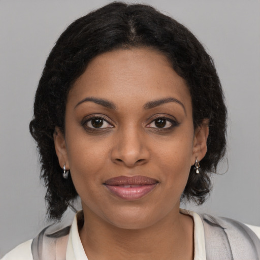 Joyful black young-adult female with medium  brown hair and brown eyes