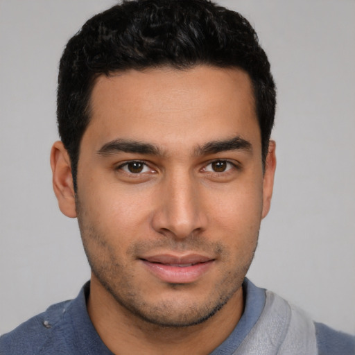 Joyful white young-adult male with short  black hair and brown eyes