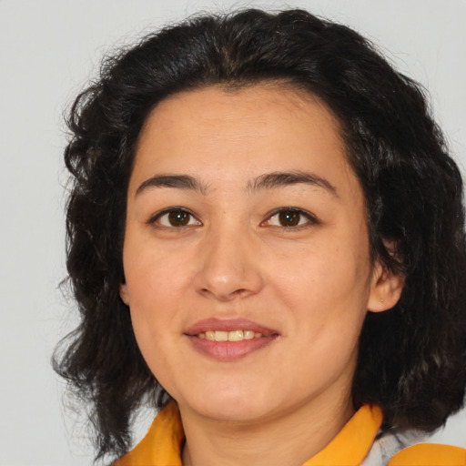 Joyful latino young-adult female with medium  brown hair and brown eyes